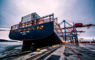 Black sail ship on body of water