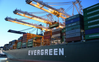 Green and gray evergreen cargo ship