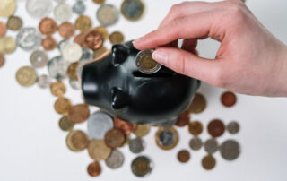 Person holding black ceramic container