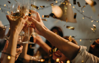 People toasting wine glasses