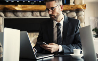 Man in black holding phone