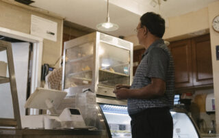 Ethnic man choosing food in store