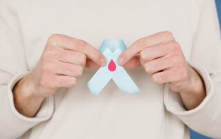 Person holding blue ribbon