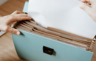 Person taking white paper from folder