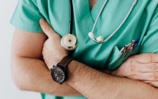 Crop doctor with stethoscope in hospital