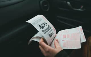 A person holding lottery tickets